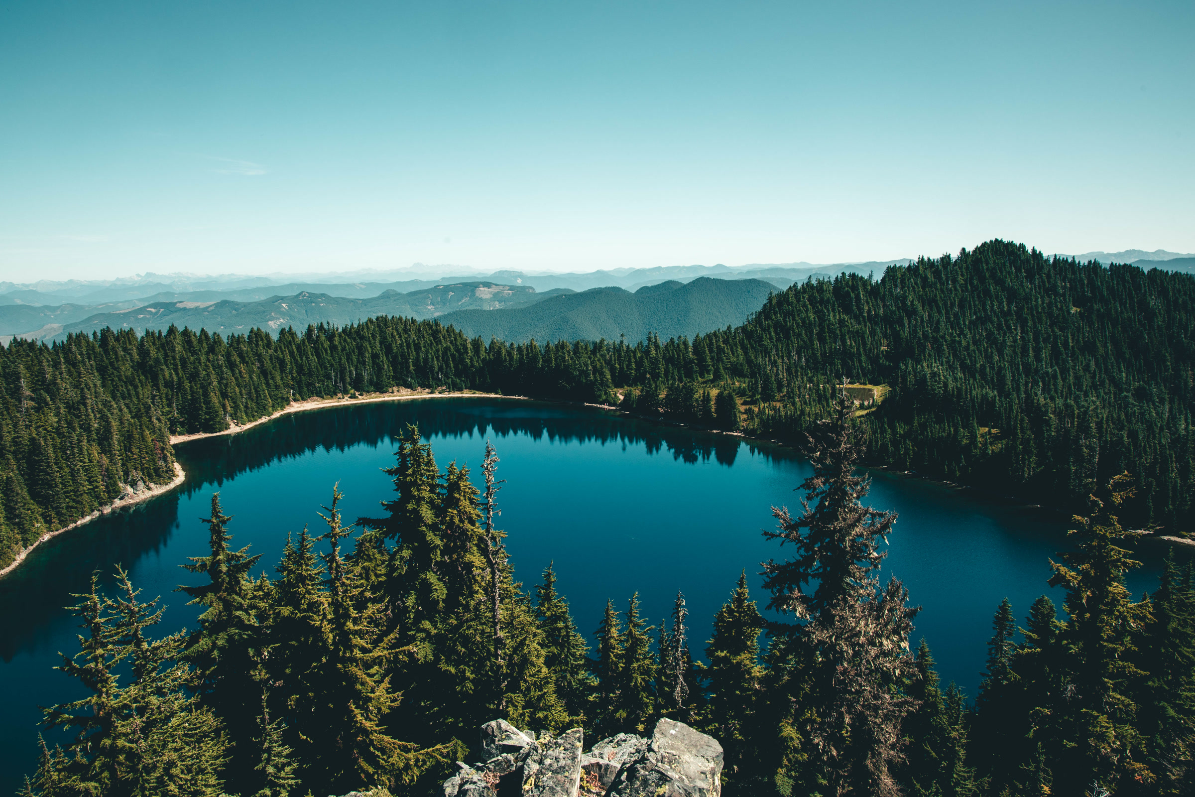 Deep blue alpine lake surrounded by evergreens