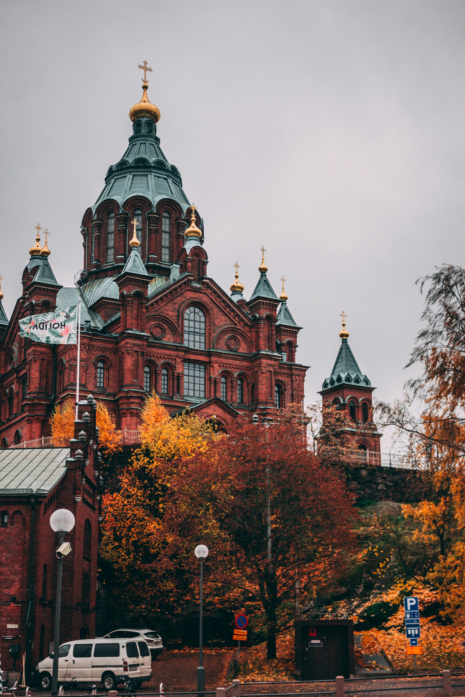 Ornate cathedral rising above an autumn street